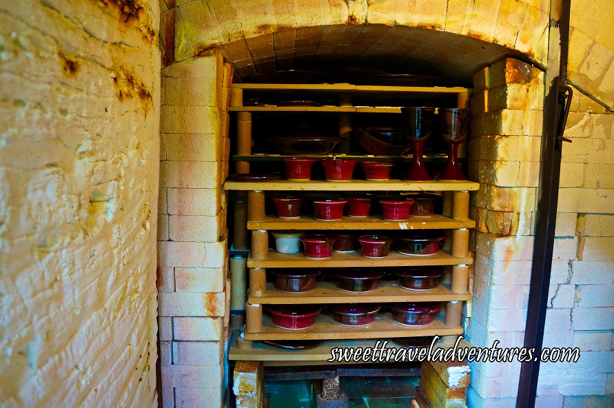 Large Kiln Made With White Bricks With Red Glazed Pottery on Shelves Inside