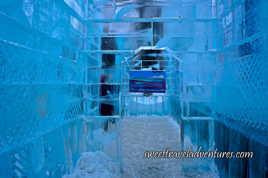 A Corridor With Ice Walls and a Doorway Looking Through to Another Room and Directly at a Painting Hanging on the Ice Wall